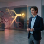 Professional analyzes a glowing holographic business journey map, showing illuminated paths to success and darker, complex routes.